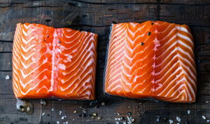 Pictured are uncooked Ora King Salmon fillets with salt and pepper garnish